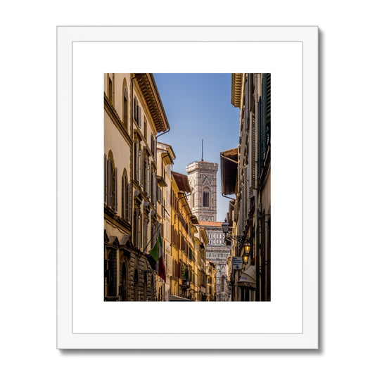Giotto's Campanile glimpsed between buildings in the city of Florence, Italy. Framed & Mounted Print