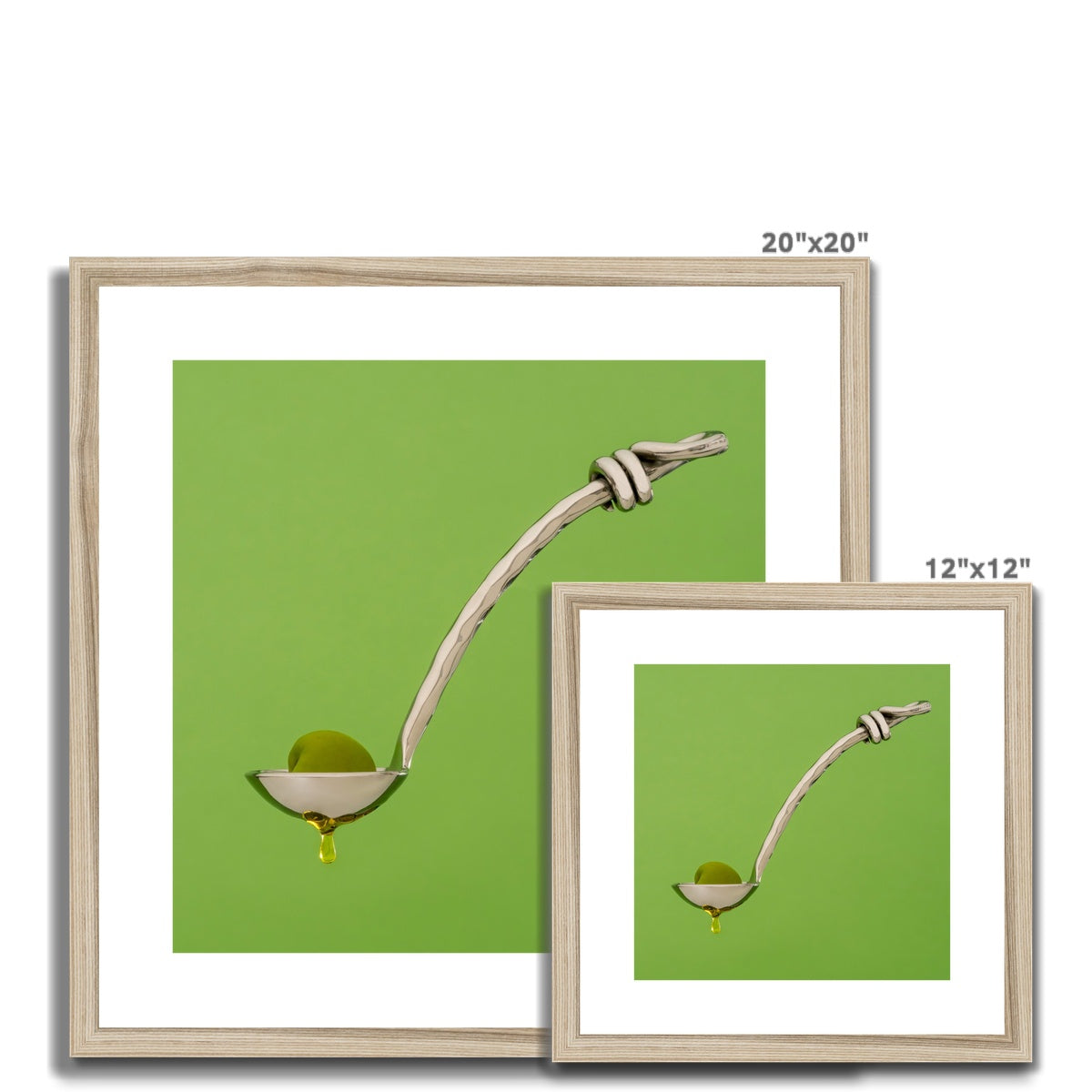 Single green olive on spoon with oil dripping. Framed & Mounted Print