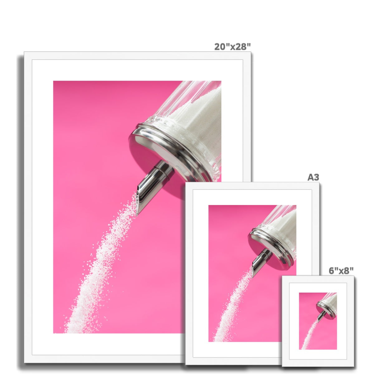 Sugar dispenser pouring against pink background Framed & Mounted Print