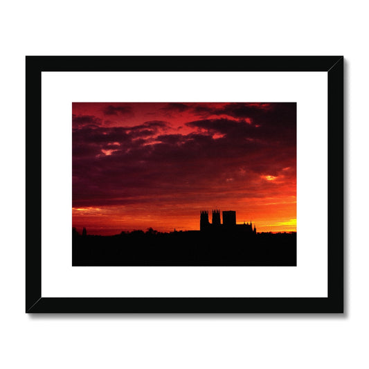 York Minster silhouetted against an orange sky at sunrise Framed & Mounted Print