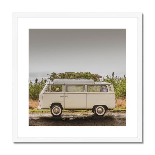 1972 VW Bay Window Campervan parked with with Christmas tree on roof and Cockapoo dog looking out of window. Framed & Mounted Print