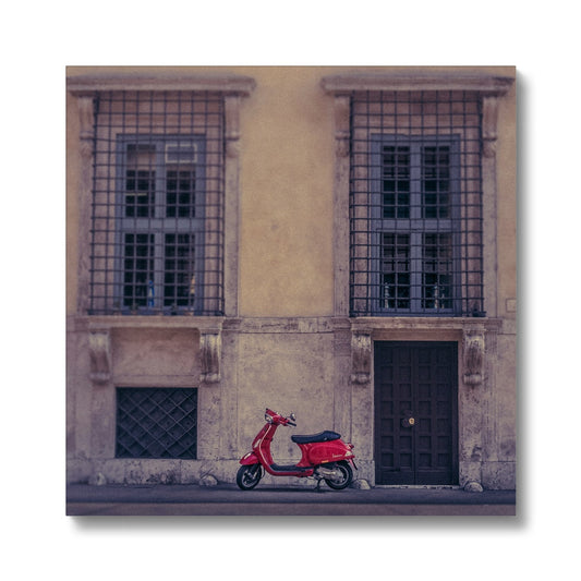 Red scooter parked outside a building in Rome, Italy. Canvas