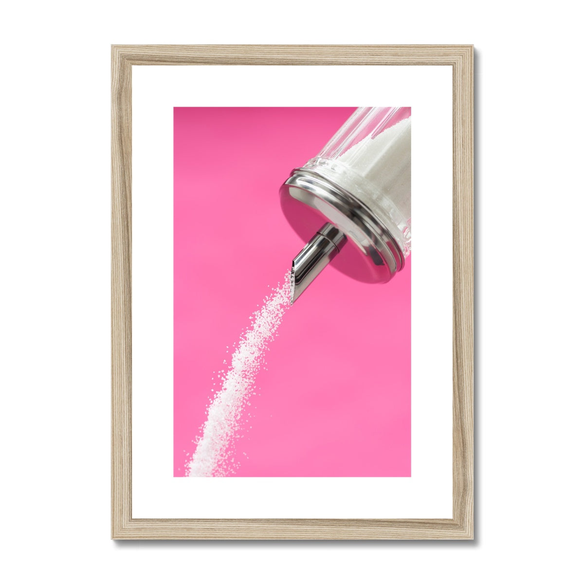 Sugar dispenser pouring against pink background Framed & Mounted Print