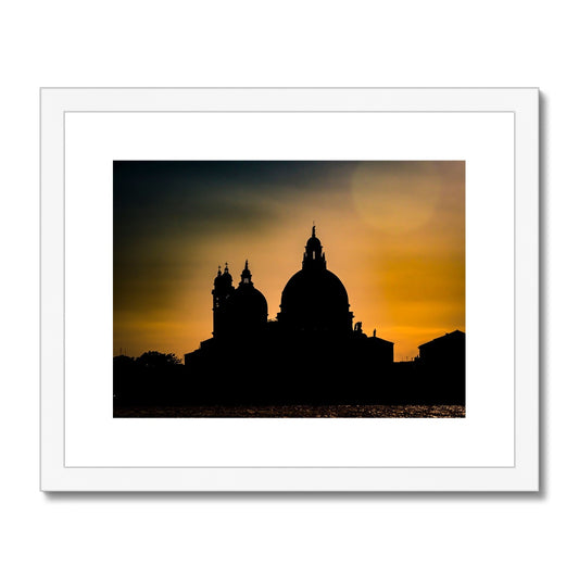 Silhouette of Santa Maria della Salute on the Grand Canal in Venice against a golden sky at sunset. Italy. Framed & Mounted Print
