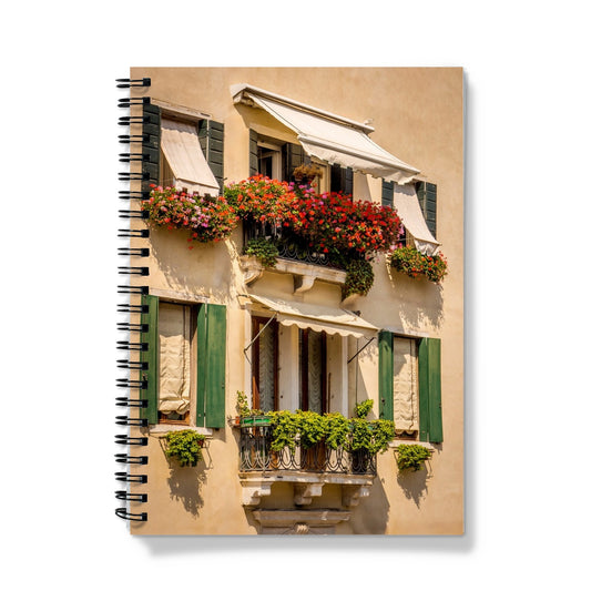 Traditional canal-side cream-rendered house with shuttered windows and window boxes. Venice. Italy. Notebook