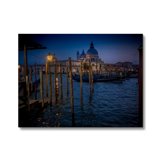 Gondolas moored for the night on the Grand Canal with the church of Santa Maria della Salute in the background. Venice, Italy. - Canvas