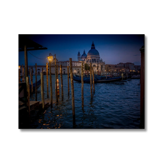 Gondolas moored for the night on the Grand Canal with the church of Santa Maria della Salute in the background. Venice, Italy. - Canvas