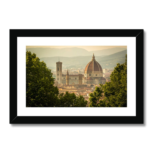 The south façade of Florence Cathedral glimpsed through the trees of San Miniato al Monte.  Italy. Framed & Mounted Print