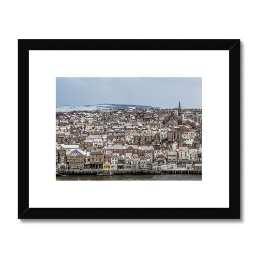View of Whitby town centre in snow from St Mary's Church, Whitby, UK. Framed & Mounted Print