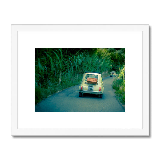 Classic Fiat 500 cars driving on a road in Florence, Italy.  Framed & Mounted Print