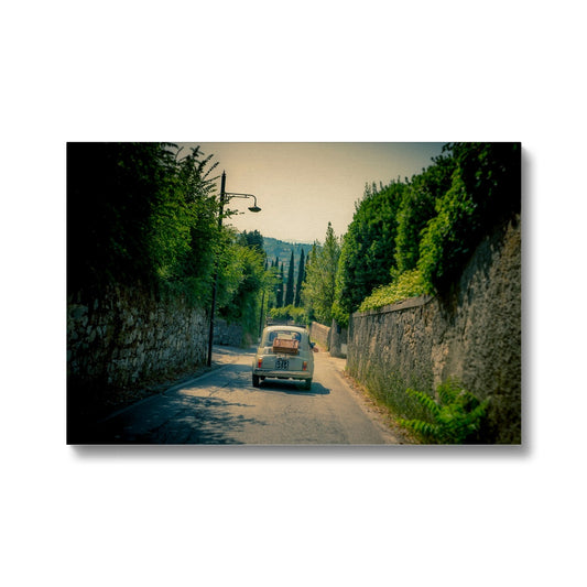 Classic Fiat 500 car driving on a road in Florence, Italy. Canvas