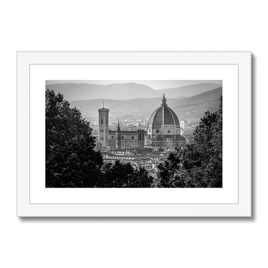 The south façade of Florence Cathedral glimpsed through the trees of San Miniato al Monte. Italy.  Framed & Mounted Print