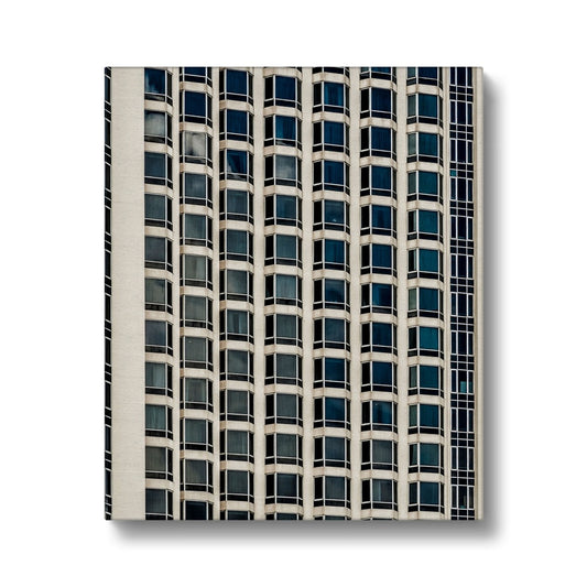 Symmetrical pattern of windows on contemporary skyscraper Canvas