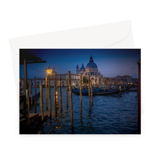 Gondolas moored for the night on the Grand Canal with the church of Santa Maria della Salute in the background. Venice, Italy. - Greeting Card