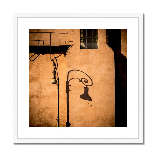 Street lamp and shadow on rendered building wall, Rome, Italy. Framed & Mounted Print