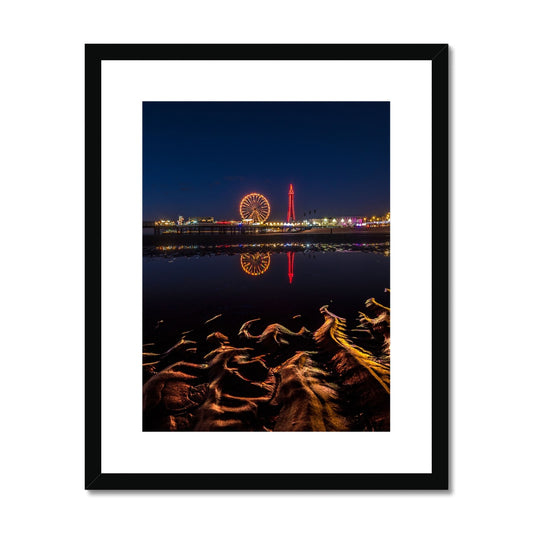 Blackpool Tower and Central Pier at night, with reflection of illuminations in water on the beach  UK. Framed & Mounted Print