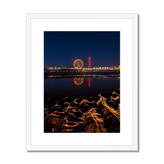 Blackpool Tower and Central Pier at night, with reflection of illuminations in water on the beach  UK. Framed & Mounted Print