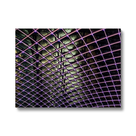 Illuminated grid pattern on a glass ceiling captured at night Canvas