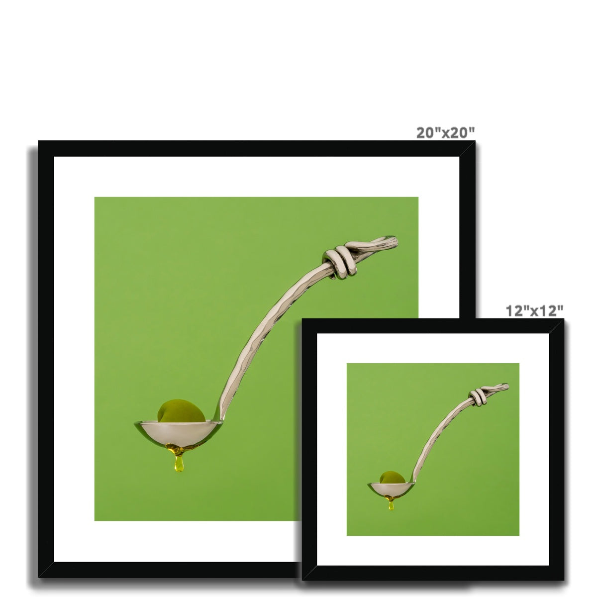 Single green olive on spoon with oil dripping. Framed & Mounted Print