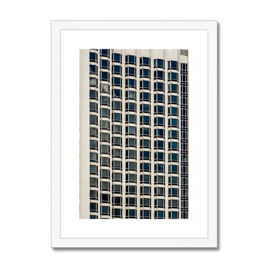 Symmetrical pattern of windows on contemporary skyscraper Framed & Mounted Print