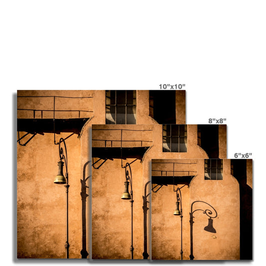 Street lamp and shadow on rendered building wall, Rome, Italy. Fine Art Print