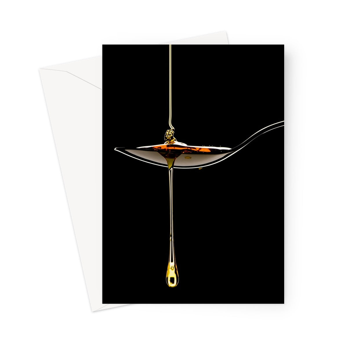 Honey pouring on to metal spoon and dripping off against black background. Greeting Card