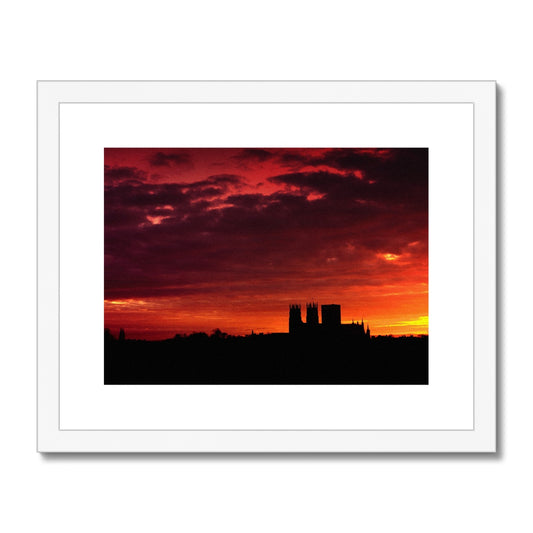 York Minster silhouetted against an orange sky at sunrise Framed & Mounted Print