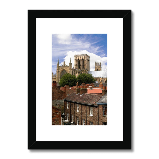 York Minster towering over York's historic rooftops. York. North Yorkshire. UK Framed & Mounted Print