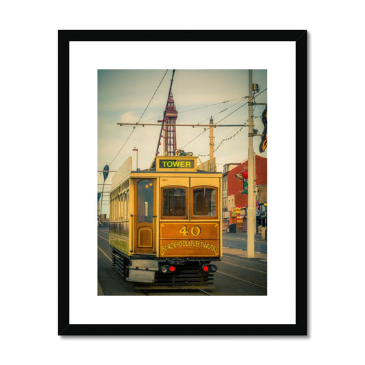 Traditional tram running along seafront promenade with Blackpool Tower in background - Blackpool,UK. Framed & Mounted Print