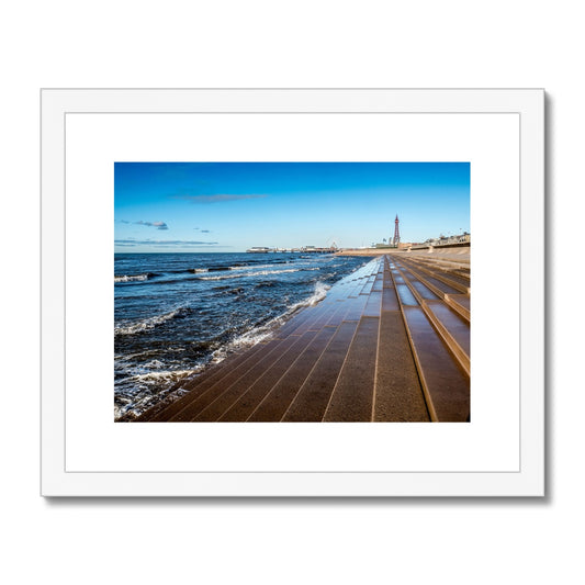 Blackpool's stone stepped sea defences with Blackpool Tower and Central Pier in the distance, Blackpool, UK. Framed & Mounted Print