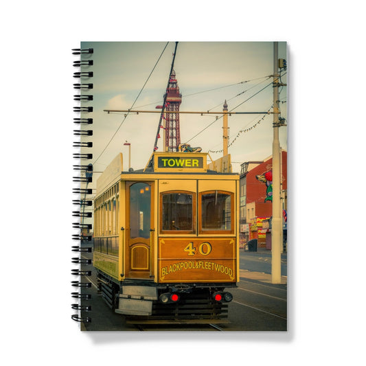 Traditional tram running along seafront promenade with Blackpool Tower in background - Blackpool,UK. Notebook