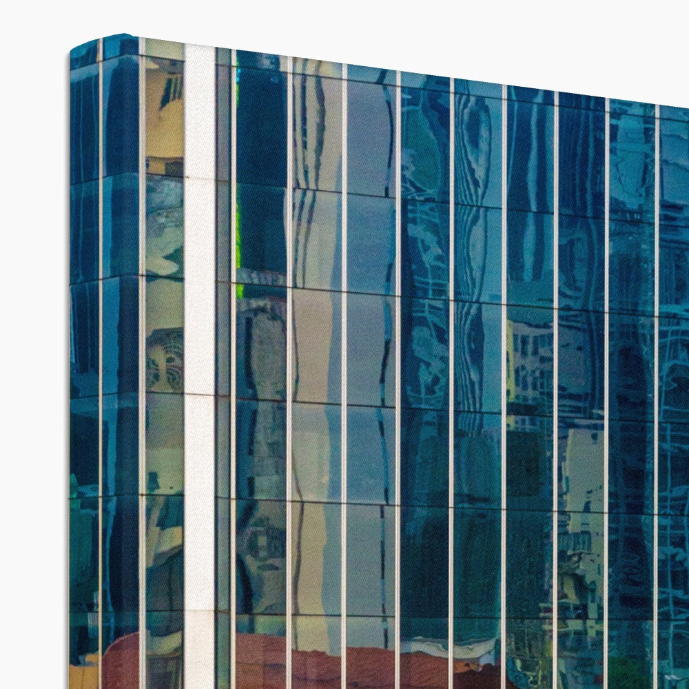 Urban reflections dance across a skyscraper's glazed facade Canvas