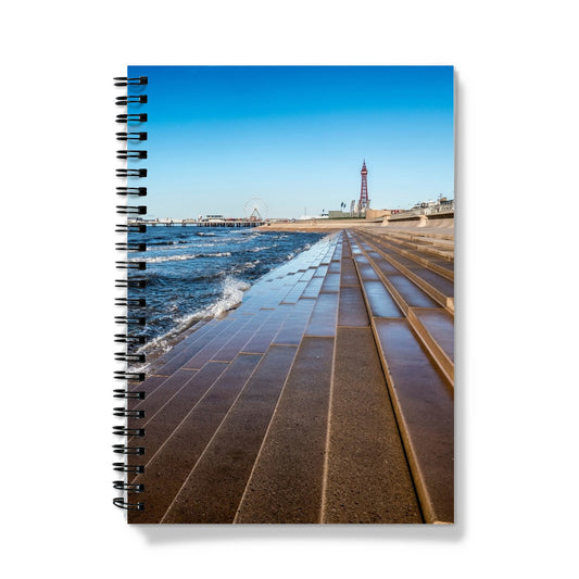 Blackpool's stone stepped sea defences with Blackpool Tower and Central Pier in the distance, Blackpool, UK. Notebook