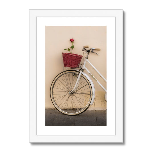 White bicycle parked against a  rendered wall with a red rose in its basket, Rome, Italy. Framed & Mounted Print