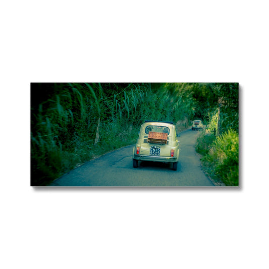 Classic Fiat 500 cars driving on a road in Florence, Italy.  Canvas