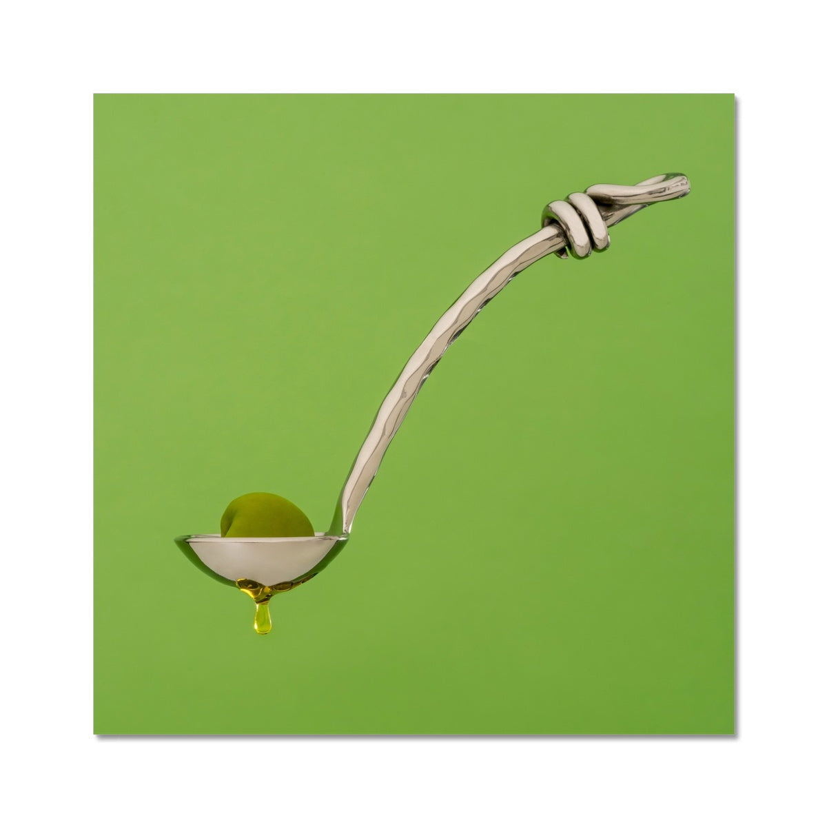 Single green olive on spoon with oil dripping. Fine Art Print