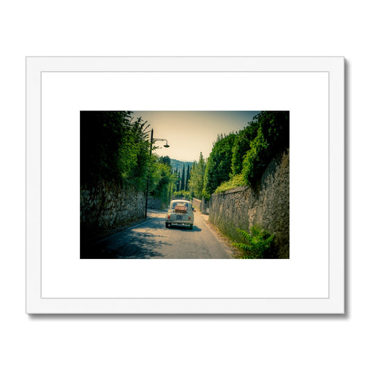 Classic Fiat 500 car driving on a road in Florence, Italy. Framed & Mounted Print