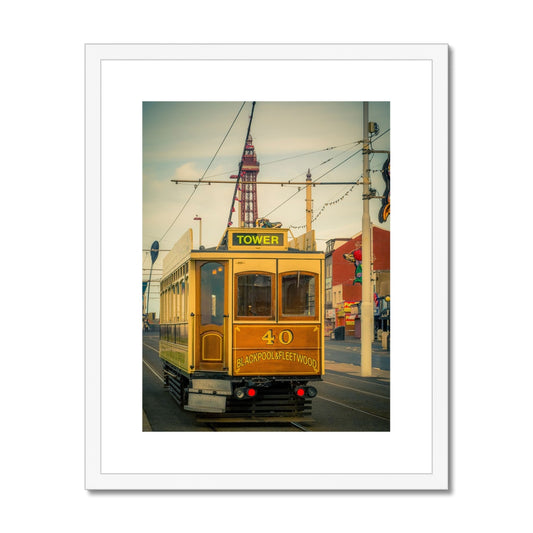 Traditional tram running along seafront promenade with Blackpool Tower in background - Blackpool,UK. Framed & Mounted Print