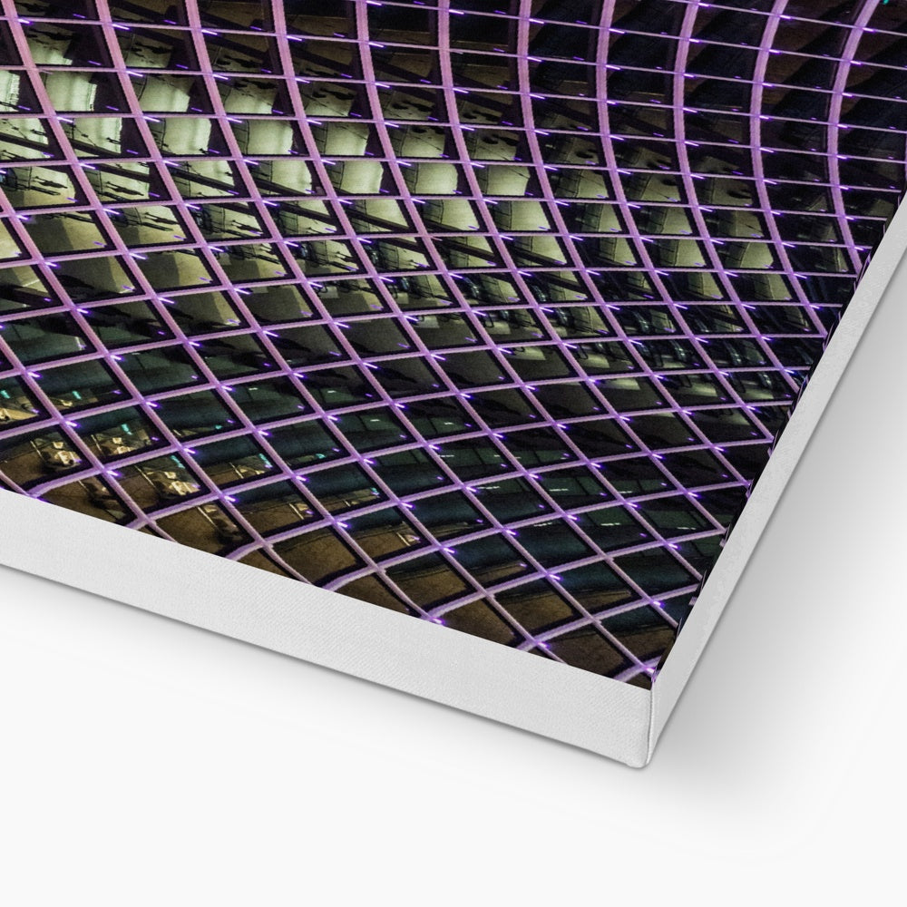 Illuminated grid pattern on a glass ceiling captured at night Canvas