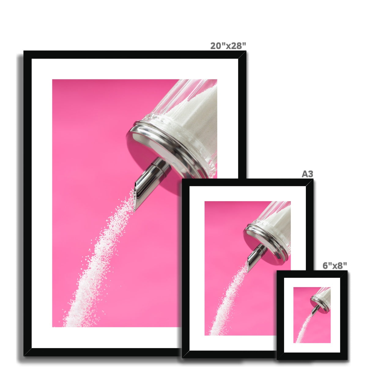 Sugar dispenser pouring against pink background Framed & Mounted Print