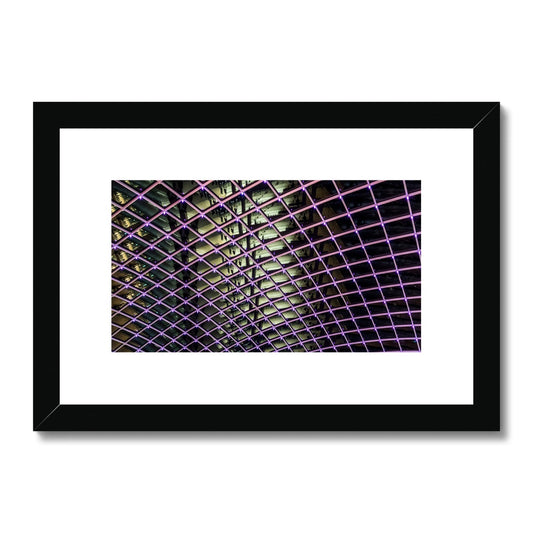 Illuminated grid pattern on a glass ceiling captured at night Framed & Mounted Print