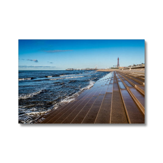 Blackpool's stone stepped sea defences with Blackpool Tower and Central Pier in the distance, Blackpool, UK. Canvas