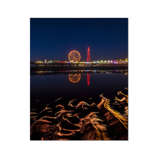 Blackpool Tower and Central Pier at night, with reflection of illuminations in water on the beach  UK. Fine Art Print