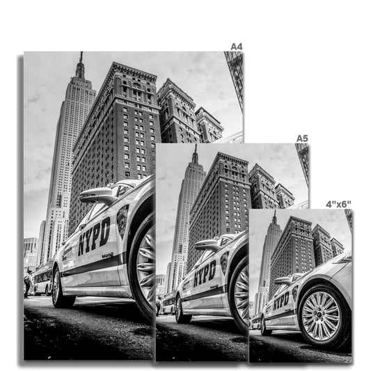 NYPD patrol car with Empire State Building on W 34th St, New York City, USA. Fine Art Print