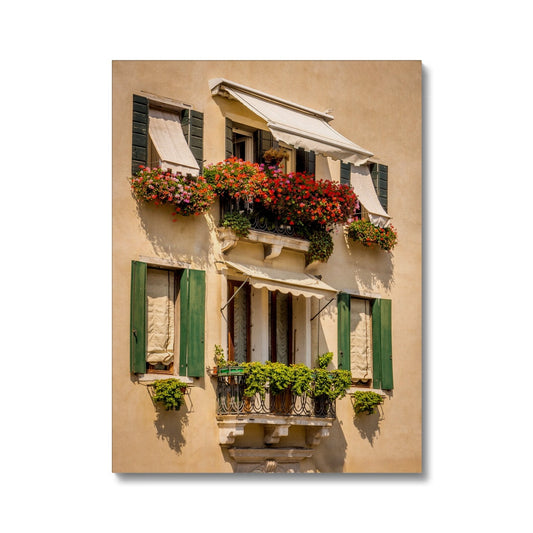 Traditional canal-side cream-rendered house with shuttered windows and window boxes. Venice. Italy. Canvas