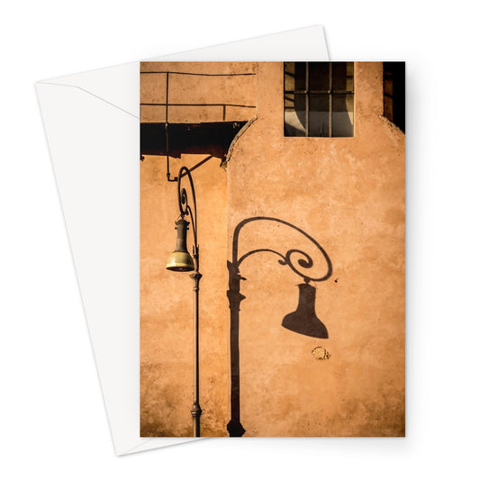 Street lamp and shadow on rendered building wall, Rome, Italy. Greeting Card