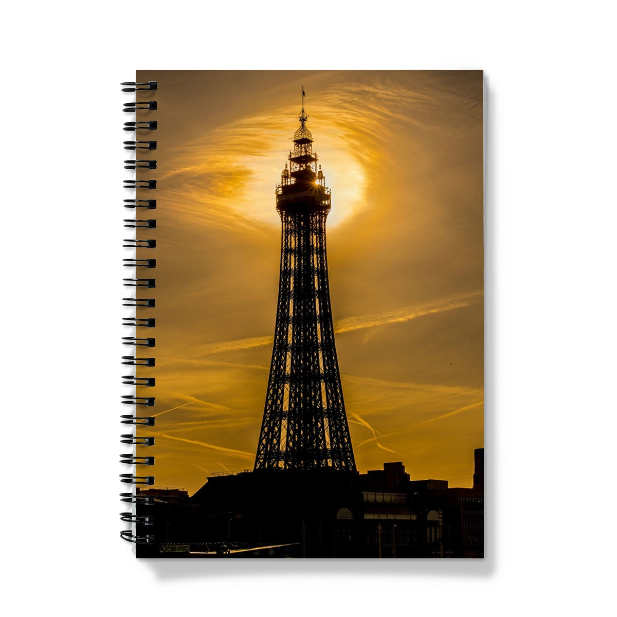 Blackpool Tower silhouetted against morning sunlight. UK. Notebook