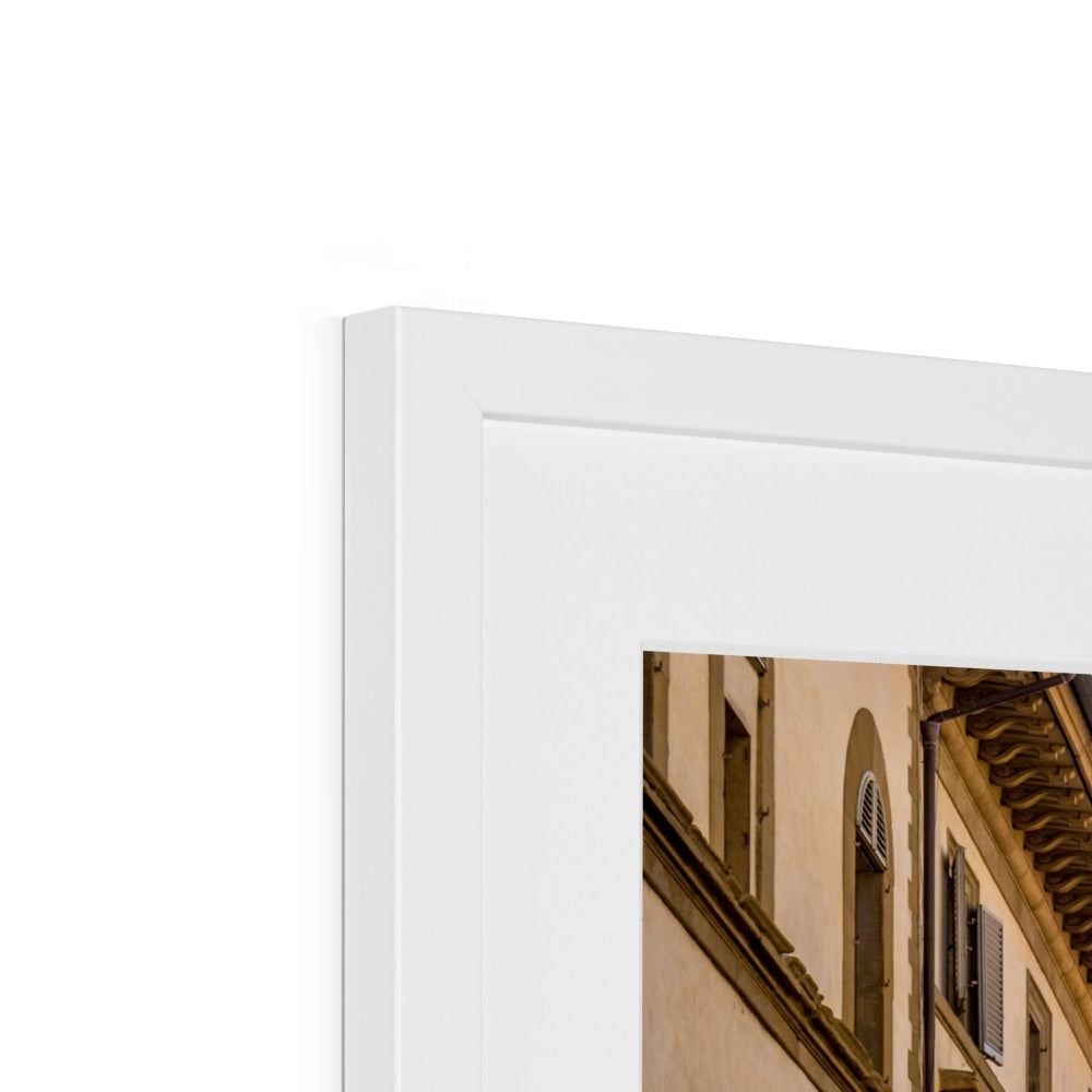 Giotto's Campanile glimpsed between buildings in the city of Florence, Italy. Framed & Mounted Print
