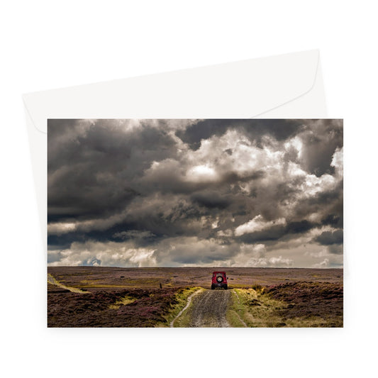 Red Land Rover Defender 110 4WD car on a Green Lane track, North Yorkshire Moors, UK. Greeting Card