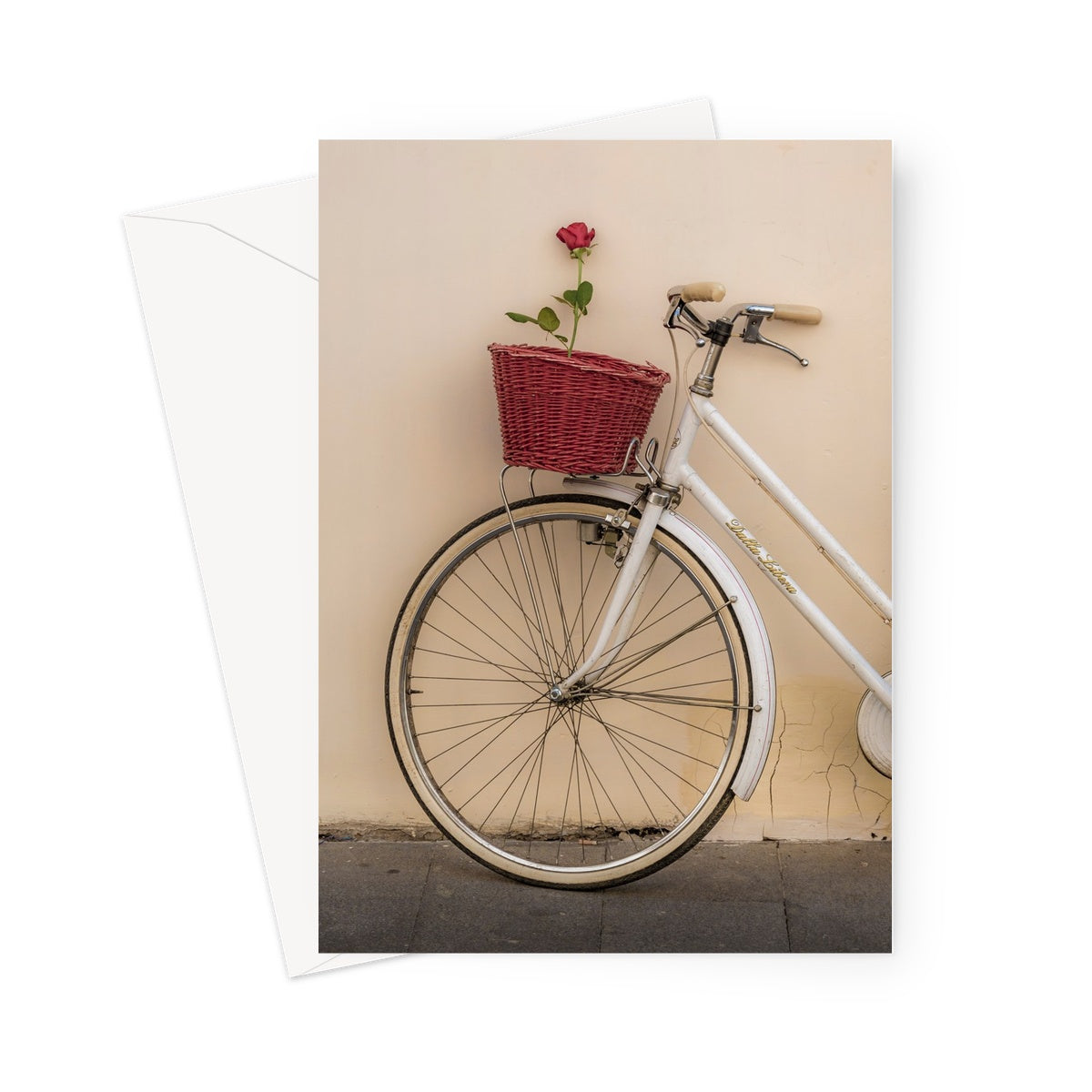 White bicycle parked against a  rendered wall with a red rose in its basket, Rome, Italy. Greeting Card